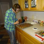 Cathy making scrumptious homemade turtles on pretzels.