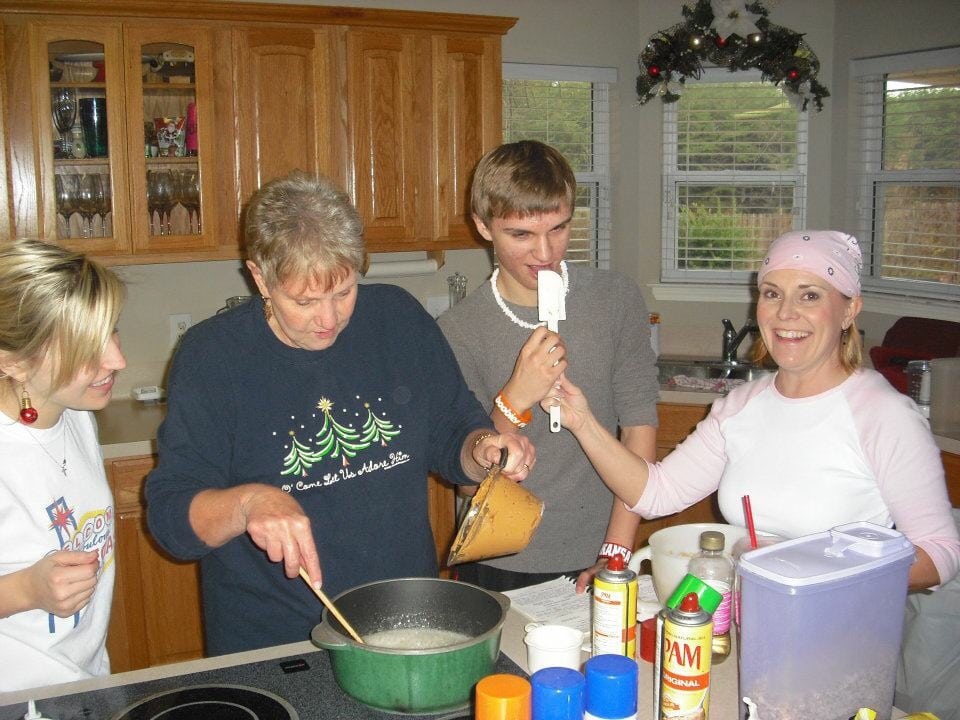 Annual Christmas Baking Day. Carolyn is cooking cereal treats in the kitchen with the grands!