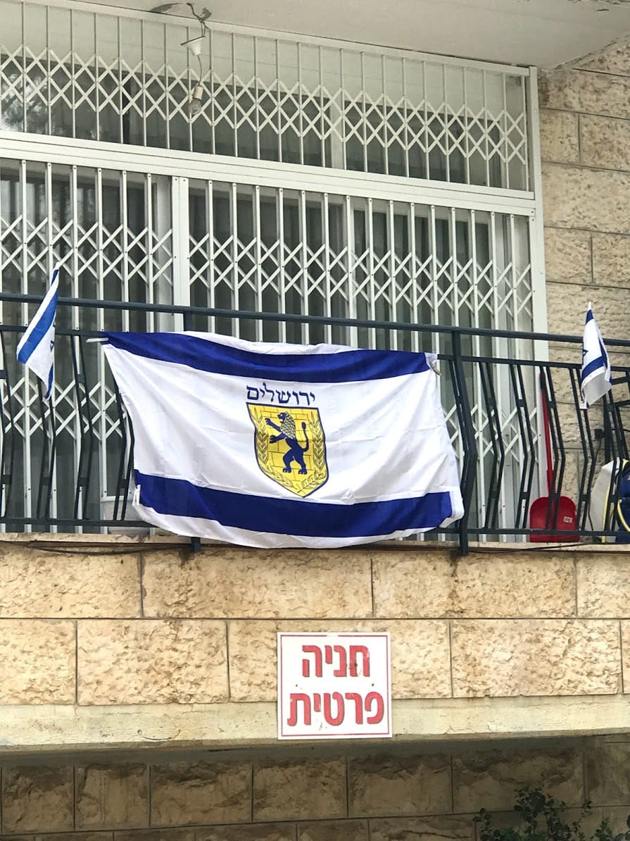 www.redneckrhapsody.com City of Jerusalem's flag mounted on the balcony of a citizen. It's flanked on either side of the Israel flag.