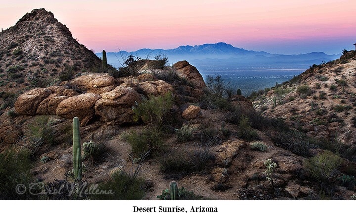 www.redneckrhapsody Dessert Sunrise, Arizona - Majestic rock formations littered with small bushes and cacti here and there with vast mountains in the back drop with a light smokey blue haze rising up from the midst lifting to a peach glow giving way to the light of a new day.