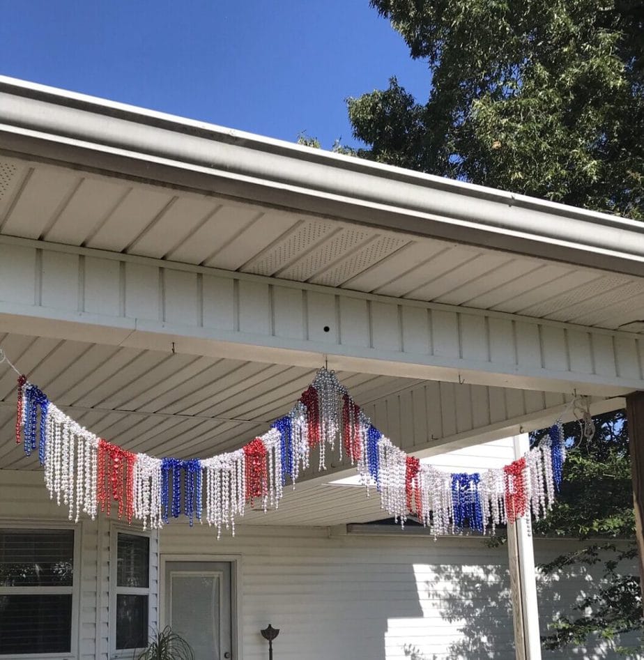 DIY twine and bead garland hanging on the back porch.