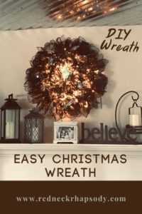 Christmas Wreath that's hanging above the mantel with decor around it.