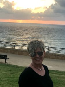 Solo tip to Israel is ending - Trina in front of sunset at the Mediterranean Sea