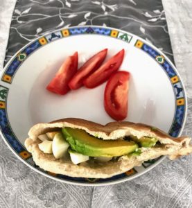 Lunch - Pita, boiled eggs, avocado, and humus with tomato as a side.