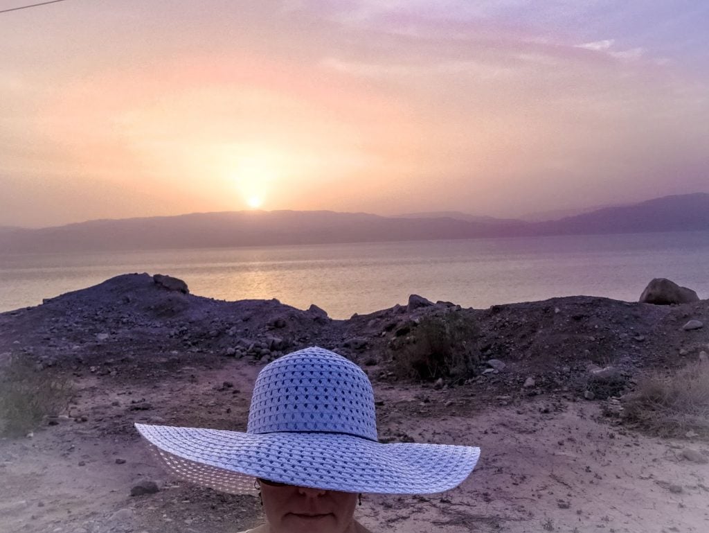 Trina solo in Israel in front of the sunrise at the Dead Sea