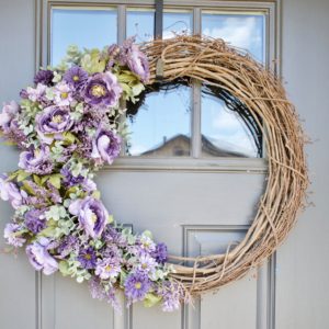 Grapevine wreath with fall lavender flowers on the left side that looks high end.