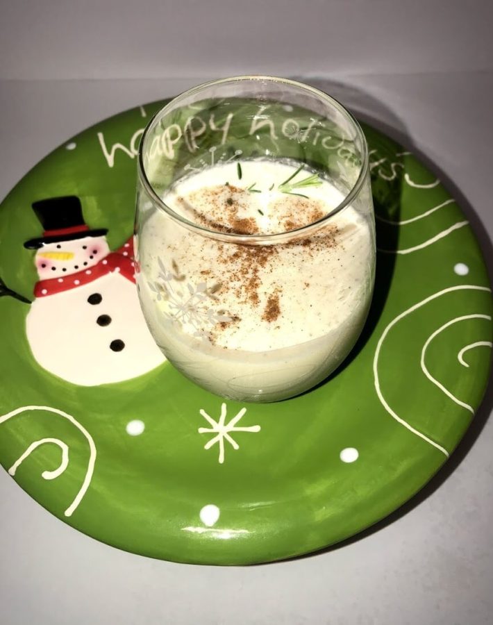 Glass of eggnog on display plate ready to drink