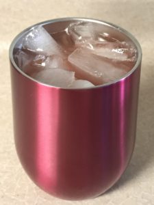 Metal insulated cup with fruity cocktail with ice.
