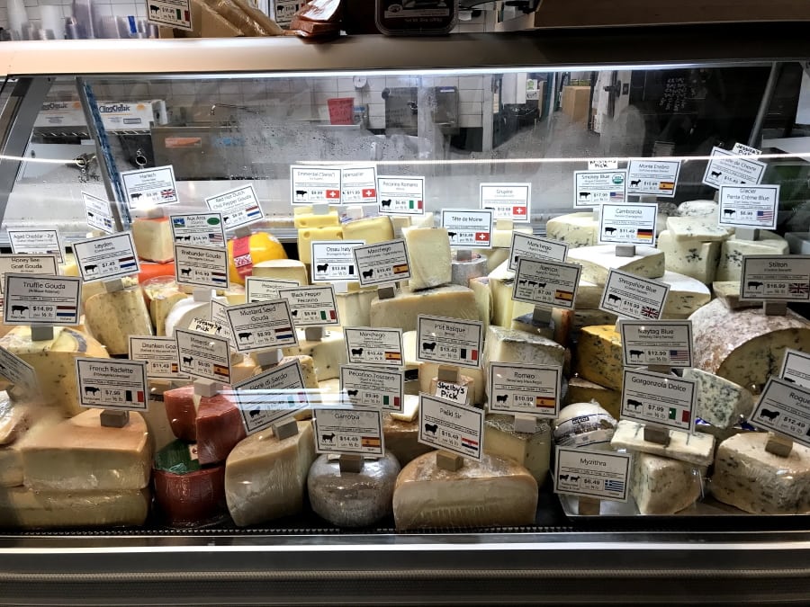 Cheese case filled with a huge array of cheeses.