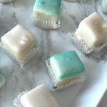 Tray of delicious petite-fours - white and teal.