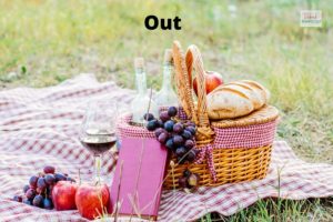 Outdoor: picnic cloth with basket of goodies & glasses of wine