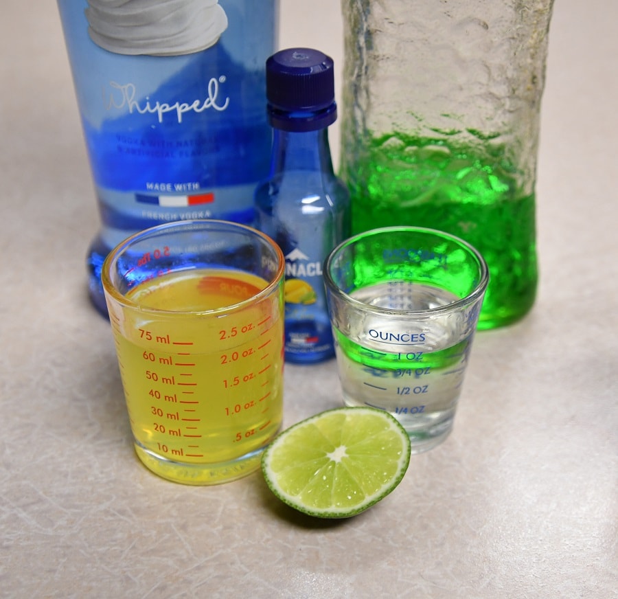 All the ingredients that you will need for a Southern Midori Sour Cocktail.