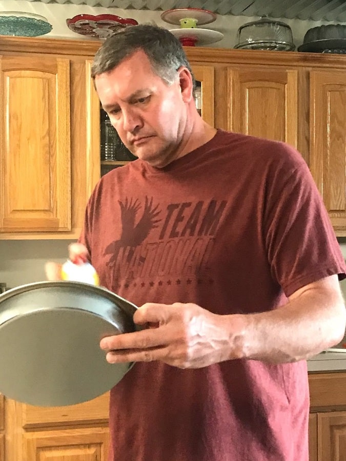 Wayne prepping pans for baking best Carrot Cake ever.