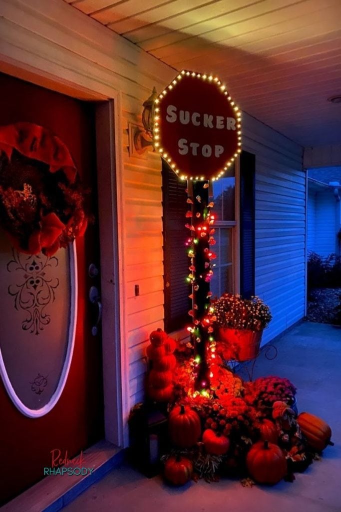 DIY Sucker Stop sign lit up and decorated for Halloween.