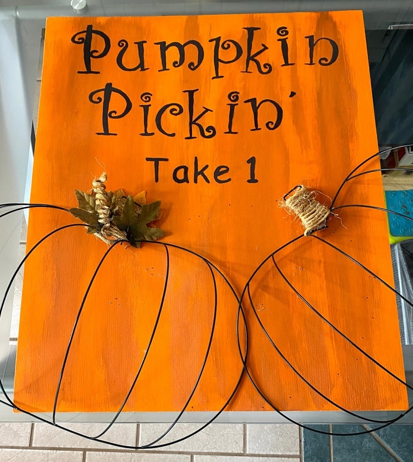 2 Dollar Tree pumpkin wire frames and orange painted board for version 1 of project.