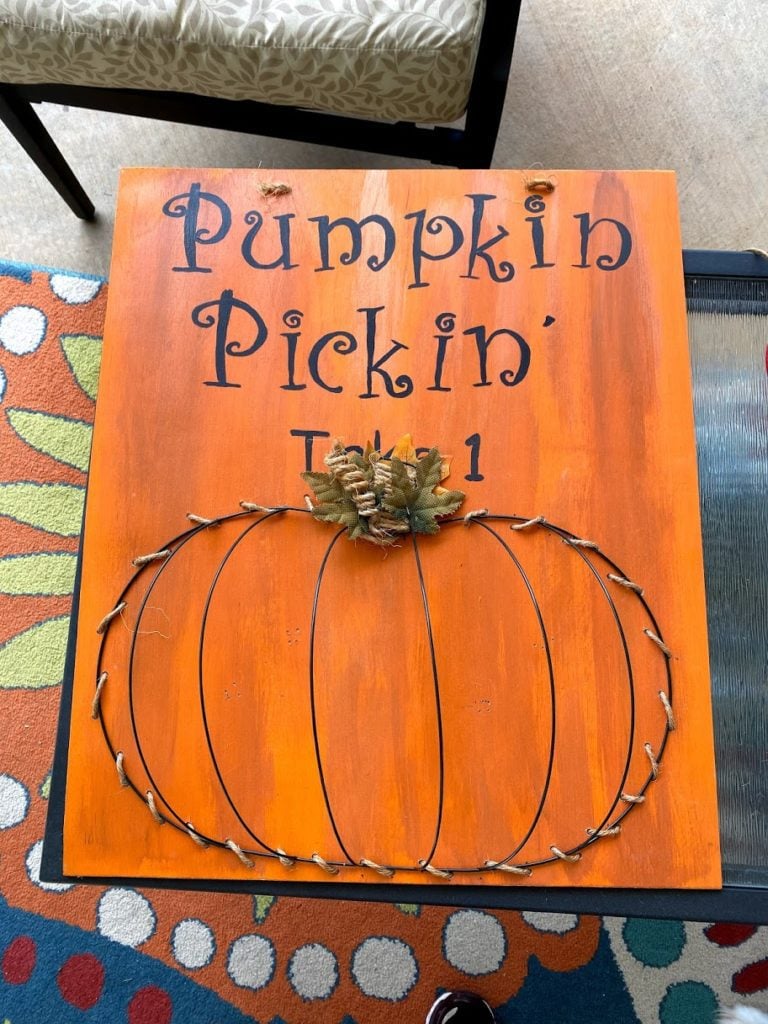 Version 2 of Pumpkin Dollar Tree wire frame laced onto board ready to hang.