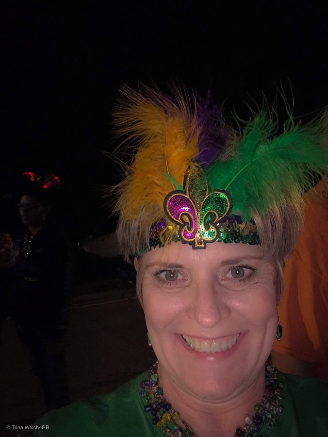 Trina in feather headband and beads ready for Selene to roll in Slidell.