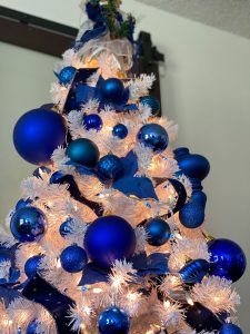 White Christmas tree with all blue and white ornaments.